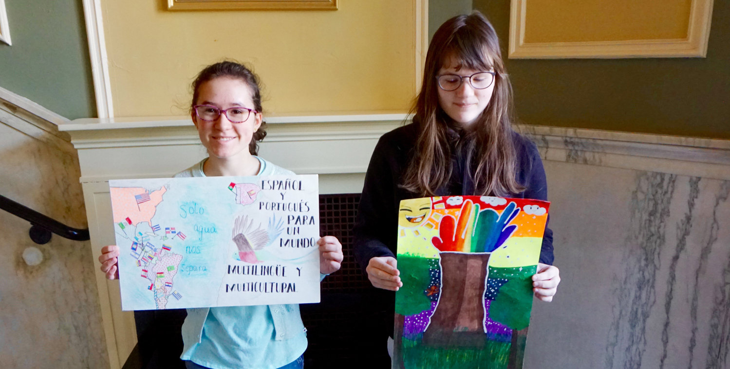 Sofia DiMascio (left) and Harriett Kay (right) proudly hold their posters before sending them to the AATSP for review on March 3.